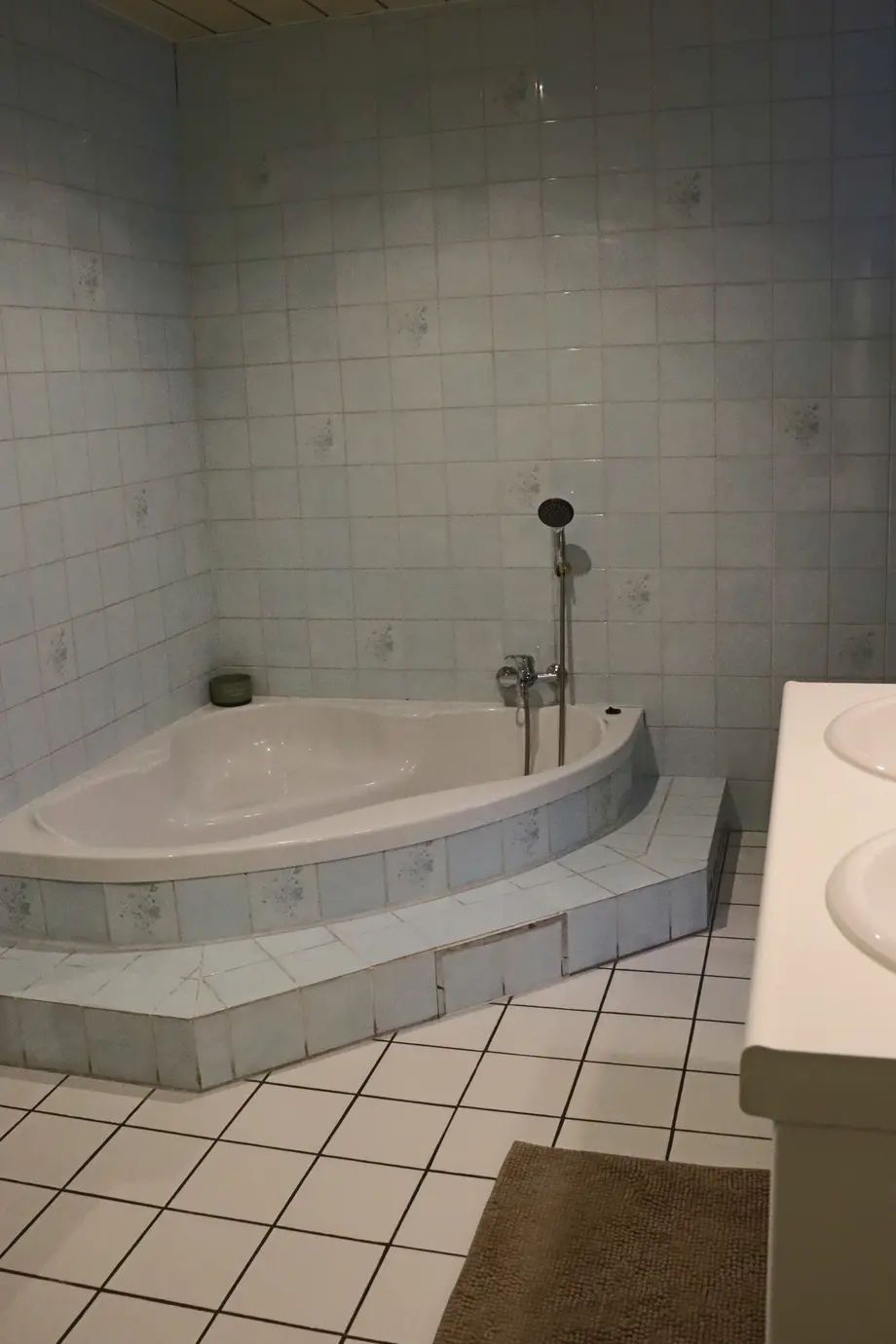 Bathroom with shower cubicle and bath, washing machine and tumble dryer